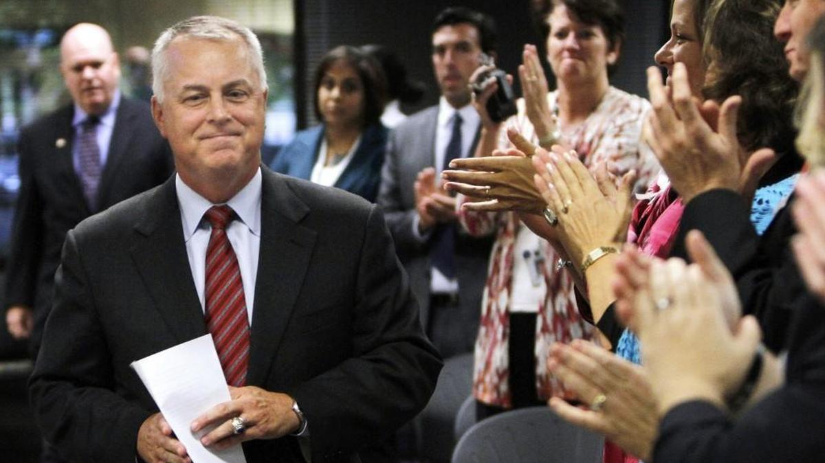 Former Wake School schools superintendent Tony Tata walks into the board room to make an announcement after he was fired from his position in 2012.