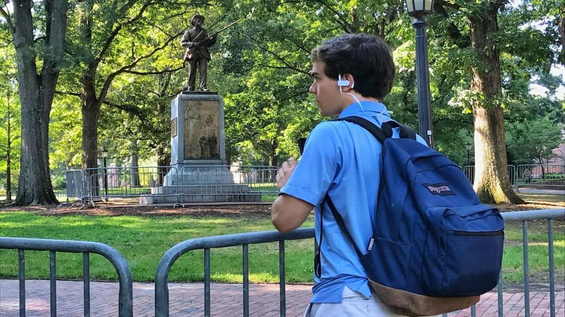 Jack Leland, a UNC sophomore, stands at one of the outer rings of barricades around the Silent Sam Confederate memorial on the UNC Chapel Hill campus in this August 2017 file photo.