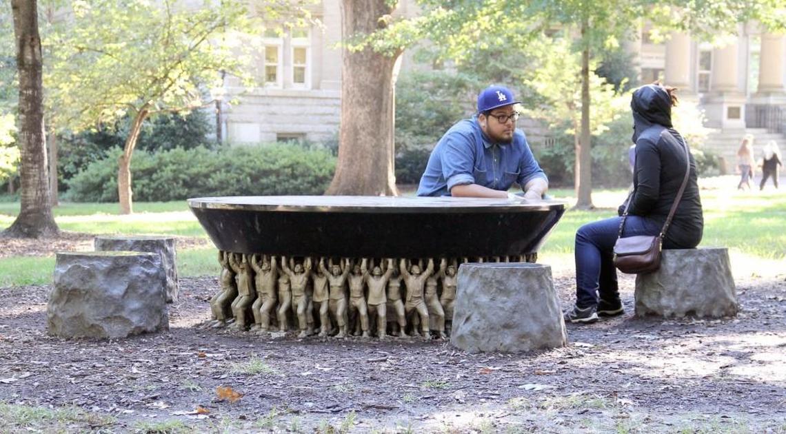 The Unsung Founders Memorial by artist Do-Ho Suh was installed on May 11, 2005, near Silent Sam on McCorkle Place. Three hundred figurines based on three larger bronze sculptures support the memorial, which is ringed by five stone seats. The inscription says, "The Class of 2002 honors the University's unsung founders - the people of color bond and free - who helped build the Carolina that we cherish today."