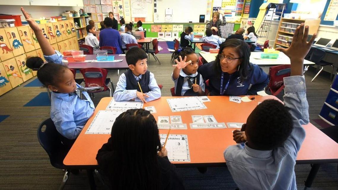 Teacher's aide Elizabeth Young (left) asks a question of her students during an English lesson at the Maureen Joy Charter School in Durham, N.C. on Dec. 20, 2016. A new state report praises Maureen Joy for its academic success on state exams with economically disadvantaged students.