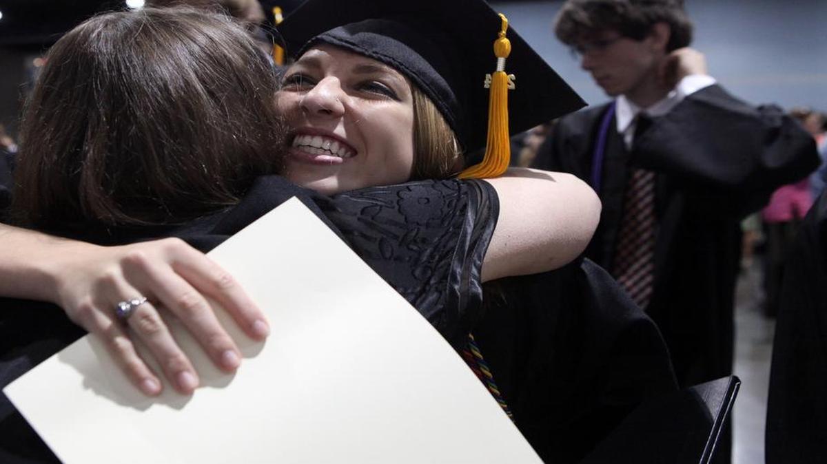 After receiving her diploma, Elora Galluzzo, 18, hugs Beth Elder, a science teacher, during the Apex High School graduation ceremony in the Raleigh Convention Center on Sunday June 8, 2014.