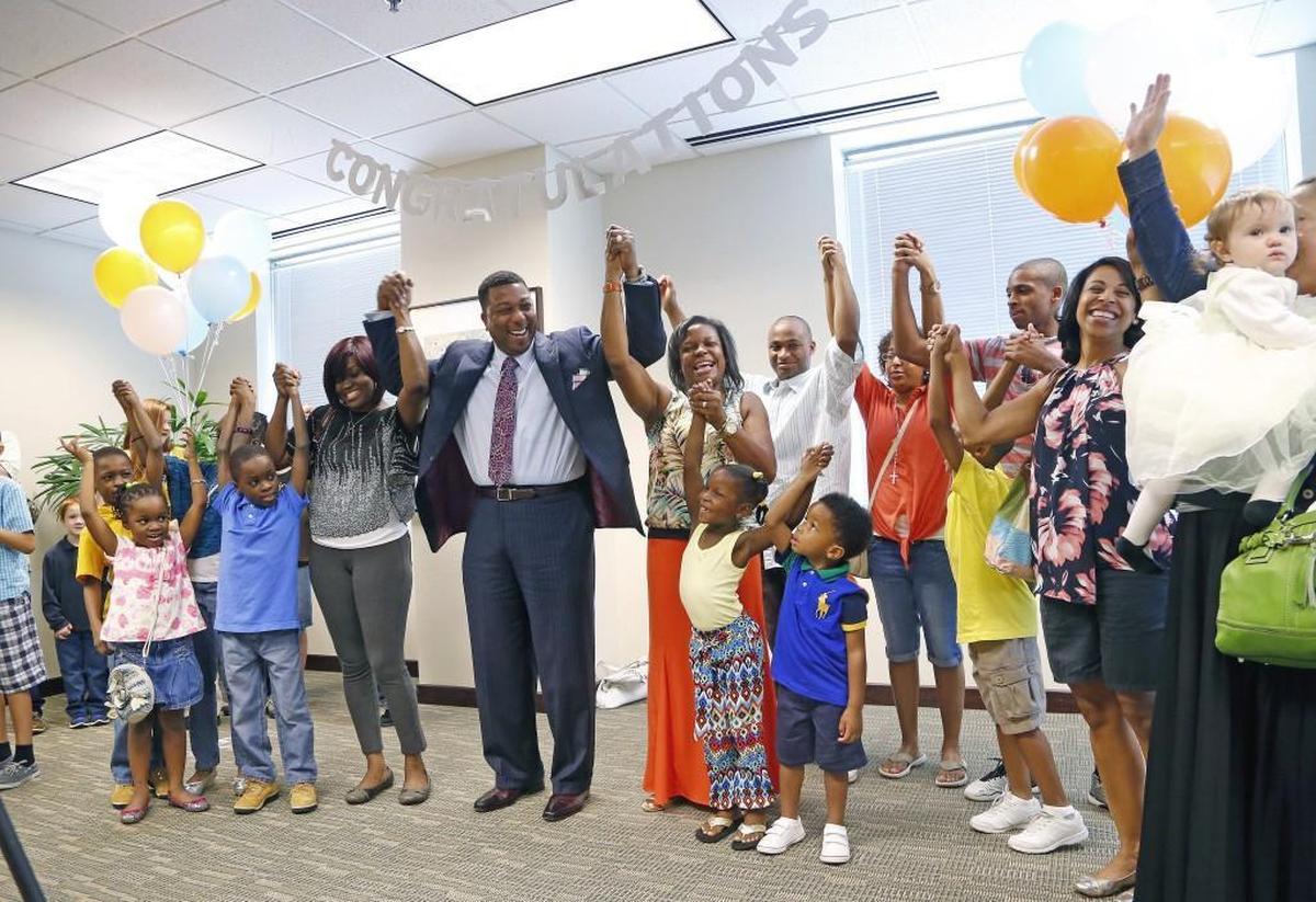 Darrell Allison, center, president of Parents for Educational Freedom in North Carolina, leads families and supporters in a group cheer in July 2015 after the the N.C. Supreme Court ruled that vouchers to attend private schools are constitutional.