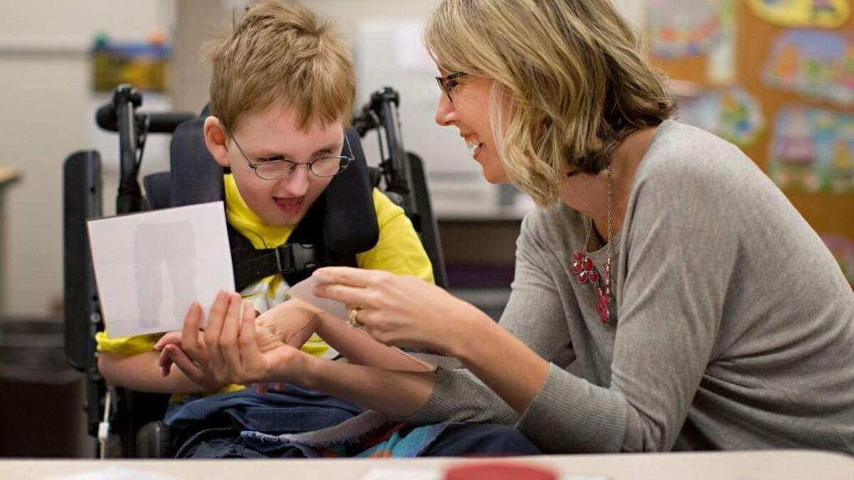 
Occupational therapist Jamie Wineland works on upper body coordination with student John Moorefield, 9, at River Bend Elementary School Wednesday, October 14, 2015 in Raleigh, N.C.
