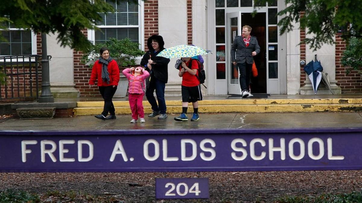 Parents and students leave Olds School in Raleigh after schools closed early due to expected wintery weather on March 3, 2014. The Wake County school system is expanding the SchoolMessenger system so that parents can receive notifications about early dismissals via text or email instead of by phone.