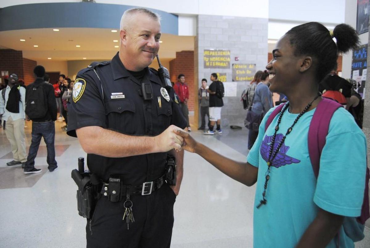 Knightdale High School resource officer Pete Smith uses a body-worn camera at the school in this 2014 file photo.
