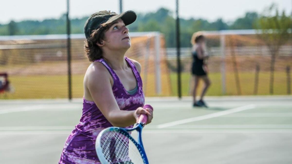 Cary High School's Amanda Demarte attempts to serve the ball during a tennis match against Apex Friendship High School on Sep. 2, 2015. Local tennis groups want the Wake County school system to open school tennis courts for use by the general public.