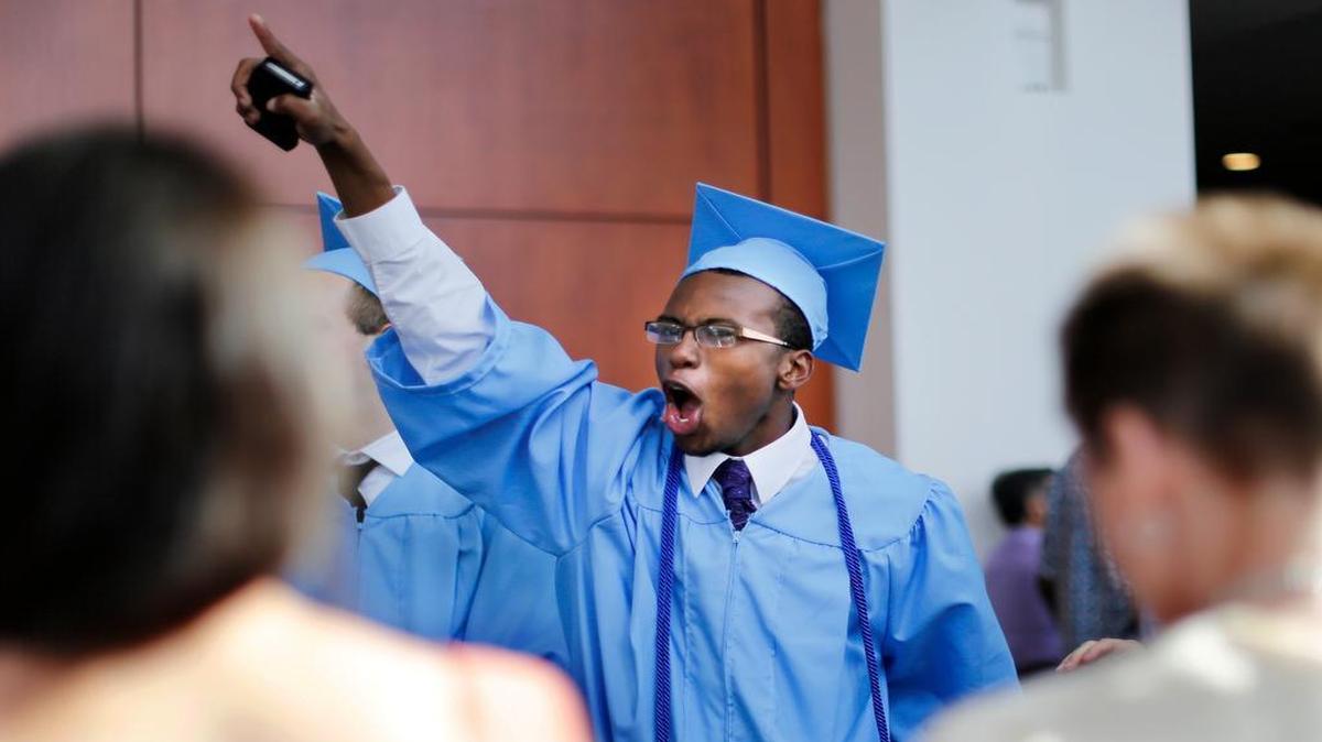 
Graduate Matthew Washington runs through the crowd cheering after Athens Drive High School's commencement on Saturday, June 7, 2014 in Raleigh, N.C.
