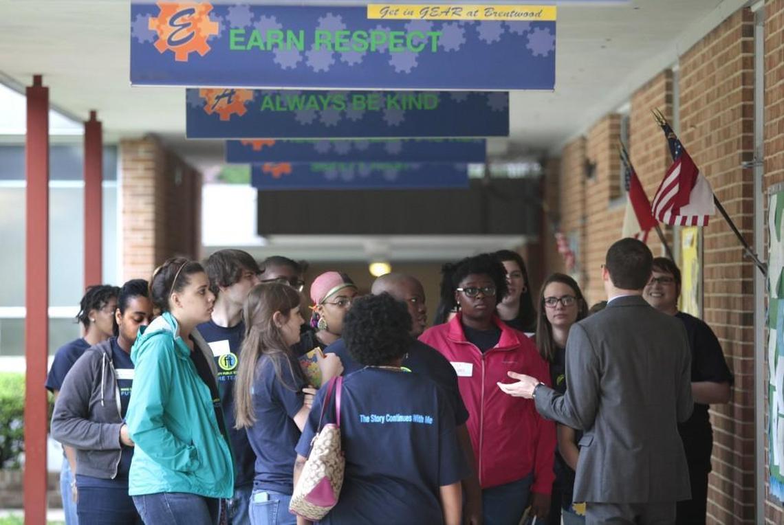 Second from right, Brentwood Elementary School of Engineering principal Robert Epler Wednesday, May 18, 2016 answers questions from a group of Wake County Public School System future teachers in an outdoors passageway of the school. Major renovations at Brenwood are recommended for inclusion in the district’s school construction program.
