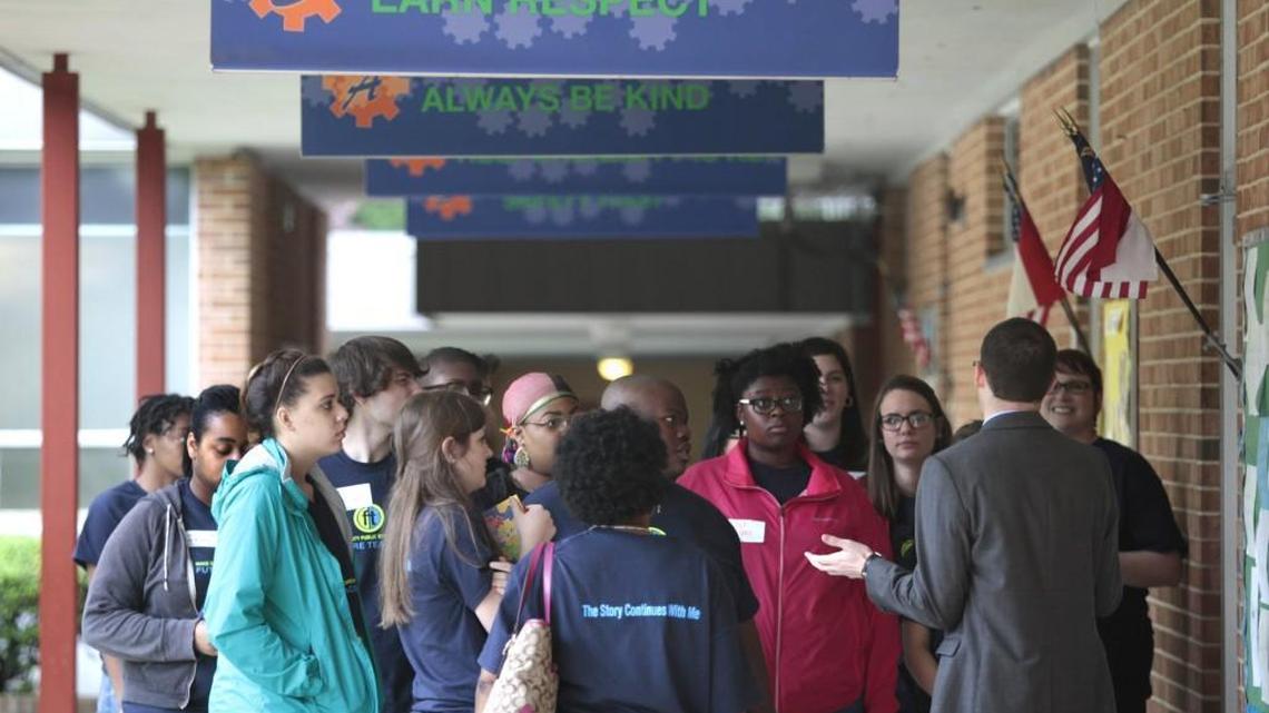 Second from right, Brentwood Elementary School of Engineering principal Robert Epler in 2016 answers questions from a group of Wake County Public School System future teachers in an outdoors passageway of the school. Major renovations at Brentwood are recommended for inclusion in the district’s school construction program.