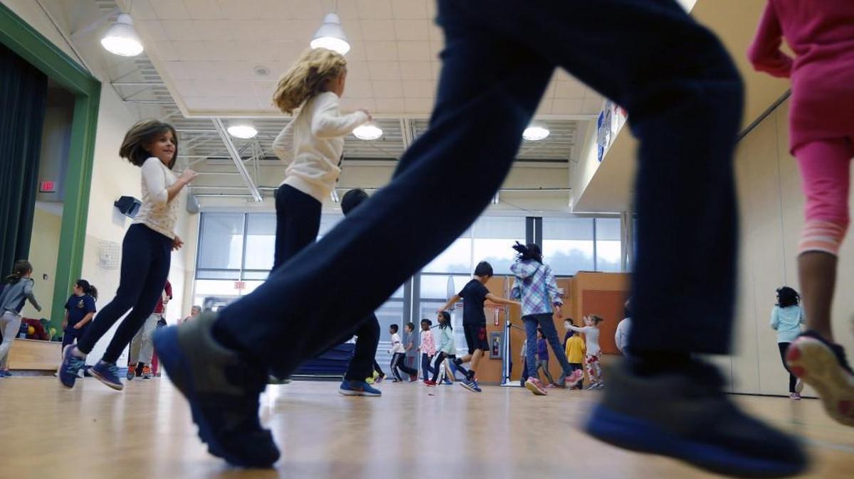 Third-graders scurry around the room during gym class at Mills Park Elementary in Cary on Nov. 22, 2016.