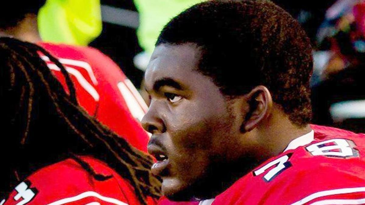 Isaiah Langston sits among teammates during Rolesville High School’s home opener against Panther Creek High on September 5, 2014. Langston, a junior lineman for the Rams, died after collapsing on the field and being rushed to the hospital on Sept. 26, 2014.