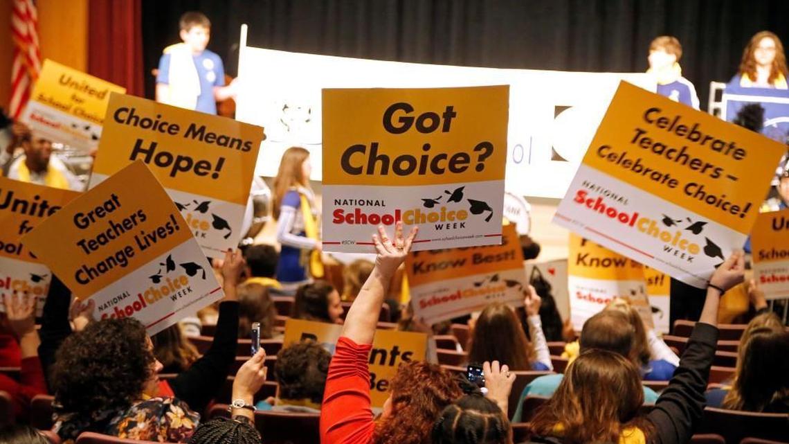 In this file photo attendees wave signs showing their support for school choice as hundreds came to a school choice rally held at the N.C. Museum of History on Jan. 23, 2018.
