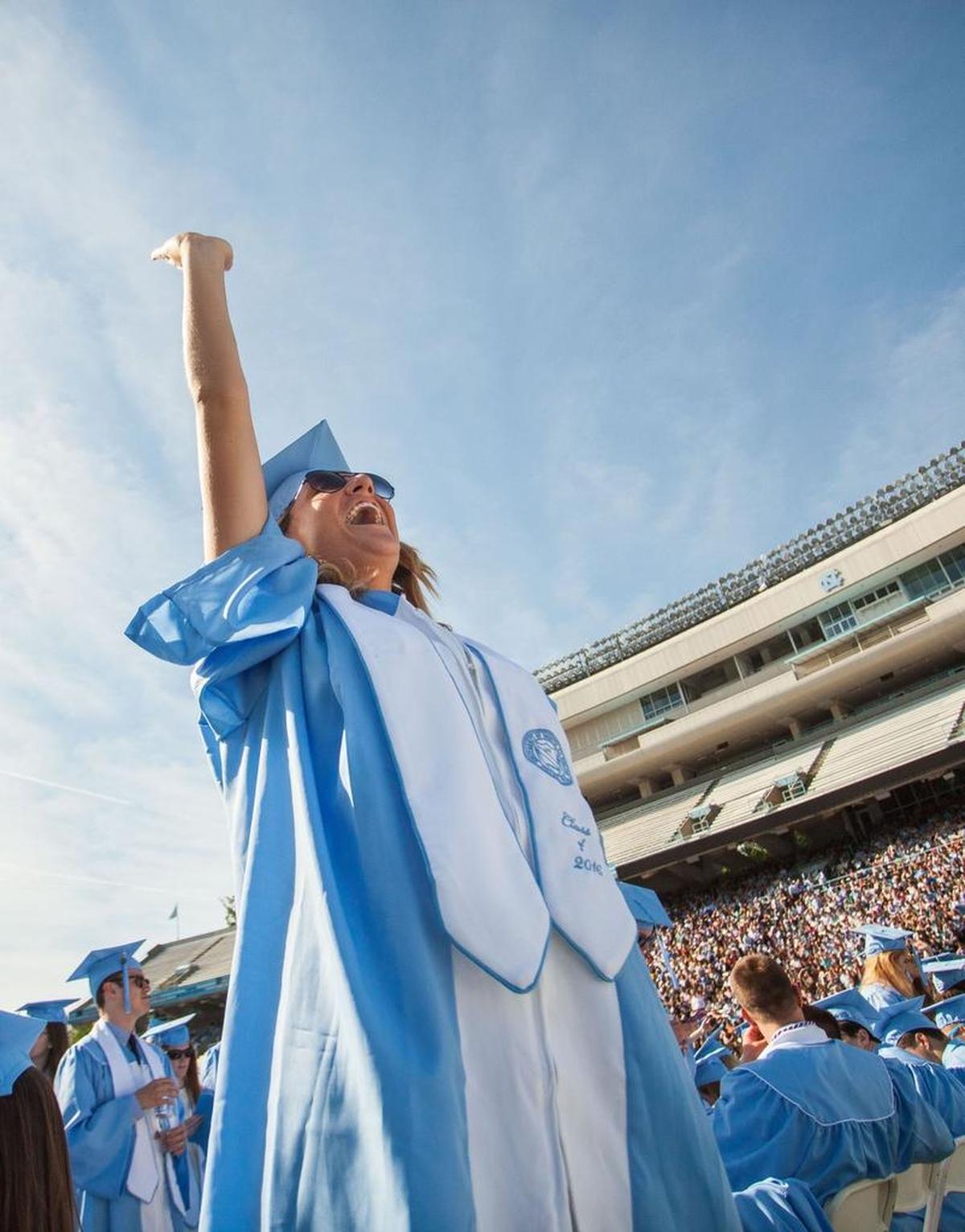 UNC class of 2016 graduate Lucie Cloak waves to spectators prior to a graduation ceremony at Kenan Memorial Stadium in Chapel Hill, N.C. on Sunday, May. 8, 2016.