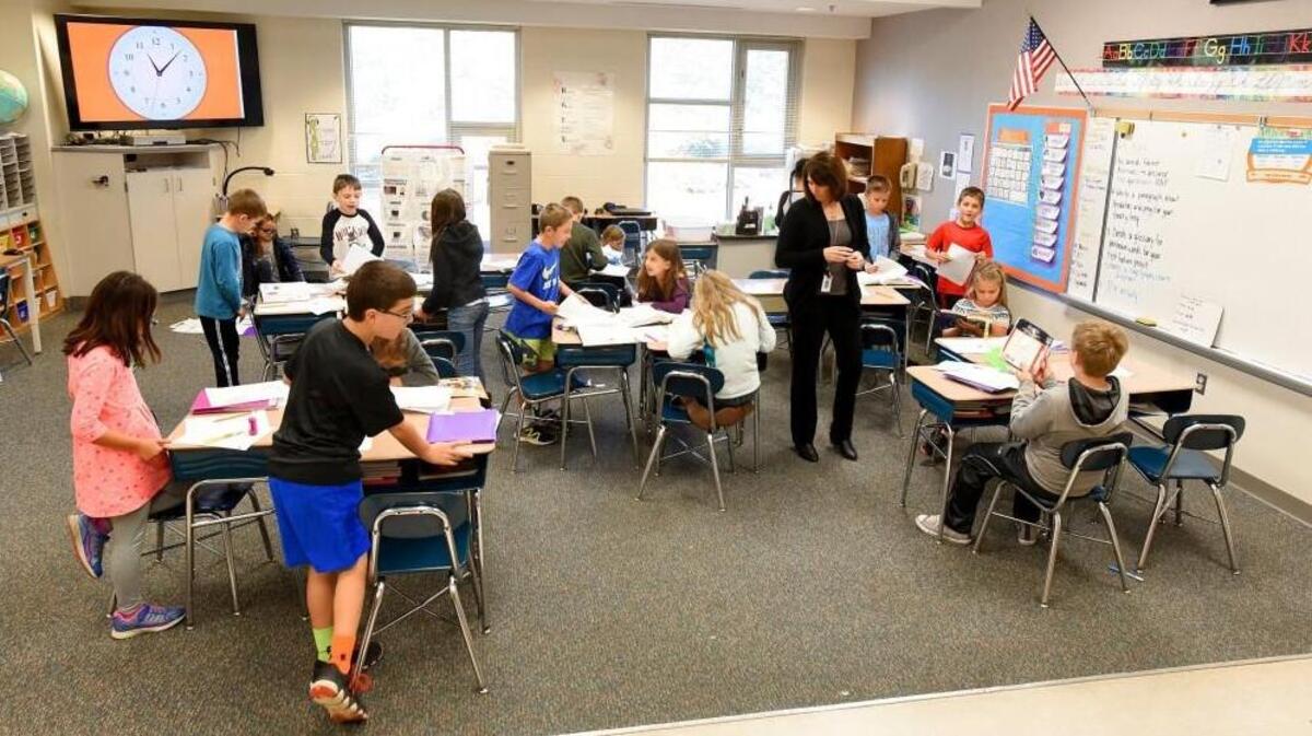 Third-grade teacher Kristi Gutshall looks over work her students are doing at Holly Grove Elementary School in Holly Springs, N.C. on Nov. 16, 2017.