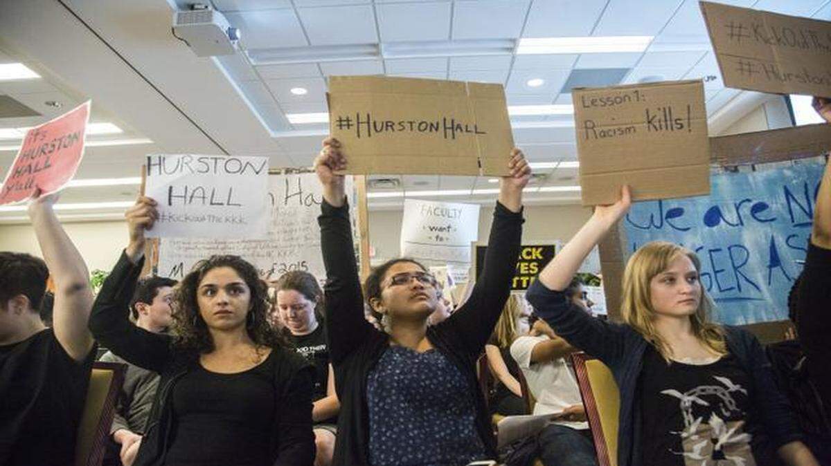 
Demonstrators from left, Jaslina Paintal Anisha Padma, and Danielle Allyn hold signs as UNC Trustees as they hear from speakers on both sides of the issue of renaming and redefining UNC-Chapel Hill campus landmarks named for Civil War participants and white supremacist leaders Wednesday, March 25, 2015 at the Rizzo Conference Center at Meadowmont in Chapel Hill. Student activists have pushed for the Chapel Hill trustees to rename Saunders Hall, which honors Confederate colonel and KKK leader William Saunders. Likewise, the students want to place a plaque next to the Silent Sam statue that would "contextualize" the Civil War soldier, and require all incoming students to be taught the racial history of UNC.
