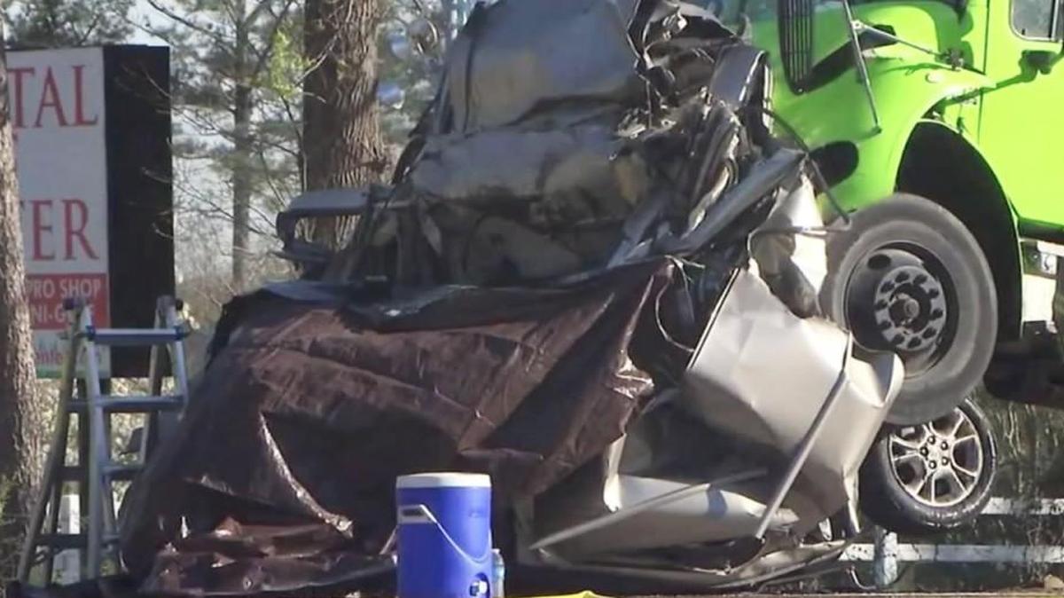 The wreckage of a minivan crushed between two trucks at the scene of an accident on Capital Boulevard near Burlington Mills Road on March 22, 2016 in Wake County. 42-year-old Michelle Simone Barlow of Wake Forest, who was driving the minivan, was killed.