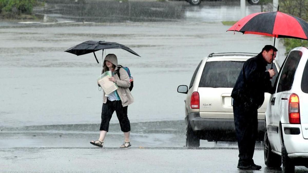 A student leaves the Vernon Malone College and Career Academy in Raleigh, N.C., Tuesday, April 25, 2017 as a security guard tells a driver they will have to turn around since the main parking lot is flooded. The vocational school had several rooms and a back hallway flooded with about two inches of water from the torrential rains associated with a slow moving cold front this morning.