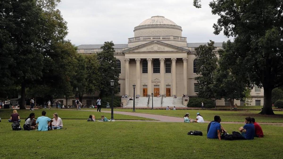 Students mingle on the quad in front of the Wilson Library on the UNC campus in Chapel Hill in August.