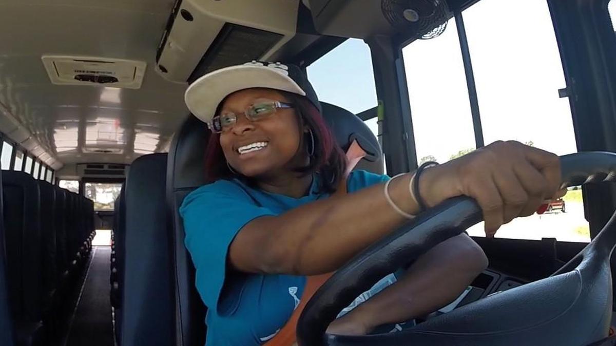 Charlene Bullock, a Wake County school system bus driver for Southeast Raleigh High School is all smiles as she makes it through pylons during the "serpentine" test at the North Carolina State fairgrounds in Raleigh, N.C. on April 27, 2016.