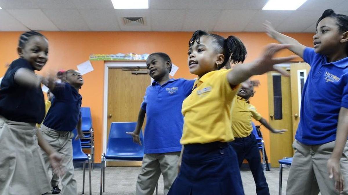 Nariah Hunter (center right), 7, dances with classmates as they sing in music class on March 15, 2016. North Carolina's Opportunity Scholarship program is making it possible for Janet Nunn's 7-year-old granddaughter, Nariah Hunter, to attend Victory Christian Center School.
