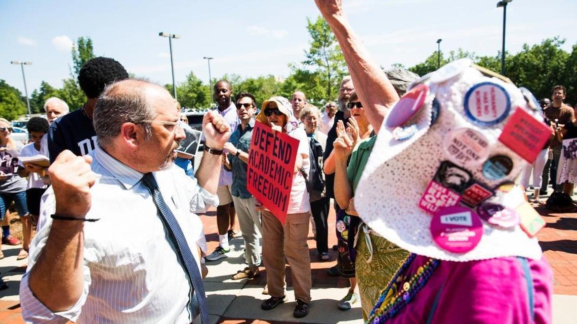 Mark Dorosin, former managing attorney of the UNC Center for Civil Rights, left, in August protested the UNC system’s move ban the center from doing legal work and has now, with fellow lawyer Elizabeth Haddix, launched the independent Julius L. Chambers Center for Civil Rights.
