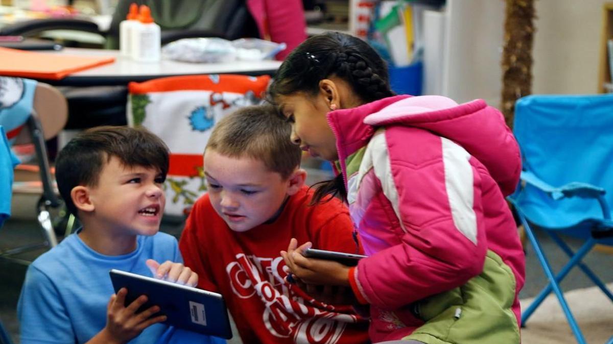 Students Jack O'Grady, left, Ryder Lawson, center, and Anwita Ambalavanan share iPads in Sarah Lloyd's first grade class at Mills Park Elementary in Cary NC on Nov. 22, 2016. Mills Park may go to art and music on a cart, have more than 29 students in fourth- and fifth-grade classes and reassign some students to other schools to meet smaller state K-3 class sizes in 2018.