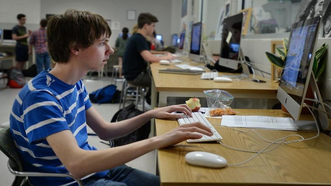 Enloe High School junior John Turlington, 17, edits a story as he skips his lunch period in Raleigh, N.C. Tuesday, April 19, 2016. He is participating in a Leadership in Media class while he works on the student newspaper, the Eagle's Eye, as the sports editor. Around 200 of Enloe's 2,500 students now skip lunch to take an extra course. That will end in August when Enloe High School adopts a block schedule that will let students take eight courses a year and still have lunch.