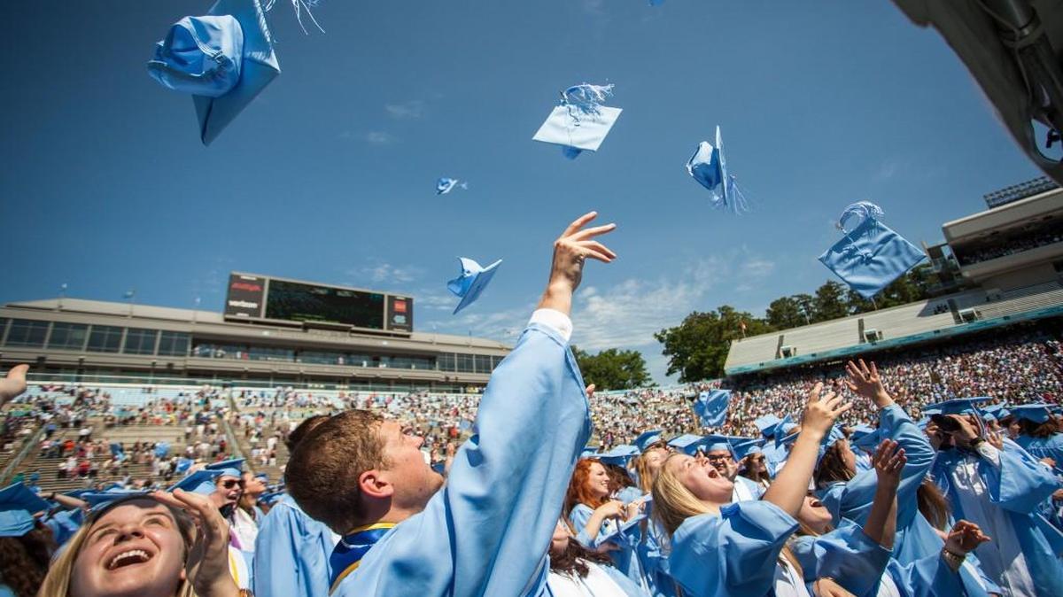 UNC class of 2016 graduates toss their caps into the air at the end of their graduation ceremony at Kenan Memorial Stadium in Chapel Hill, N.C. on Sunday, May 8, 2016.