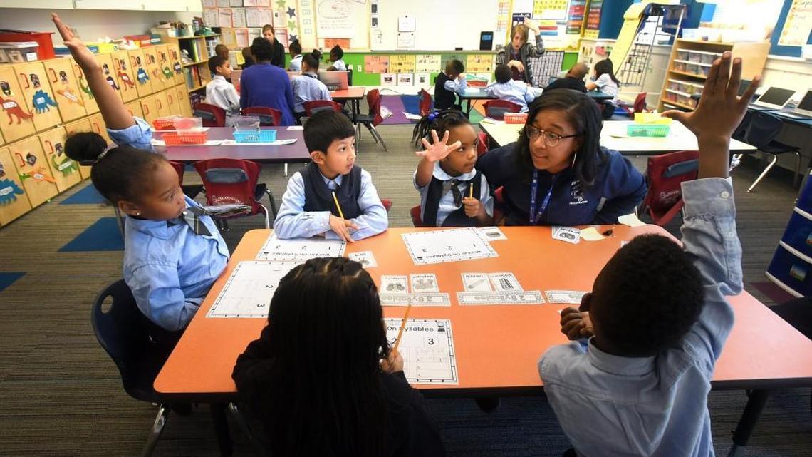 Teacher's aide Elizabeth Young, left, asks a question of her students during an English lesson at the Maureen Joy Charter School in Durham in December 2016. Maureen Joy Charter School is a K-8 public charter school and is tuition free and open to the public.