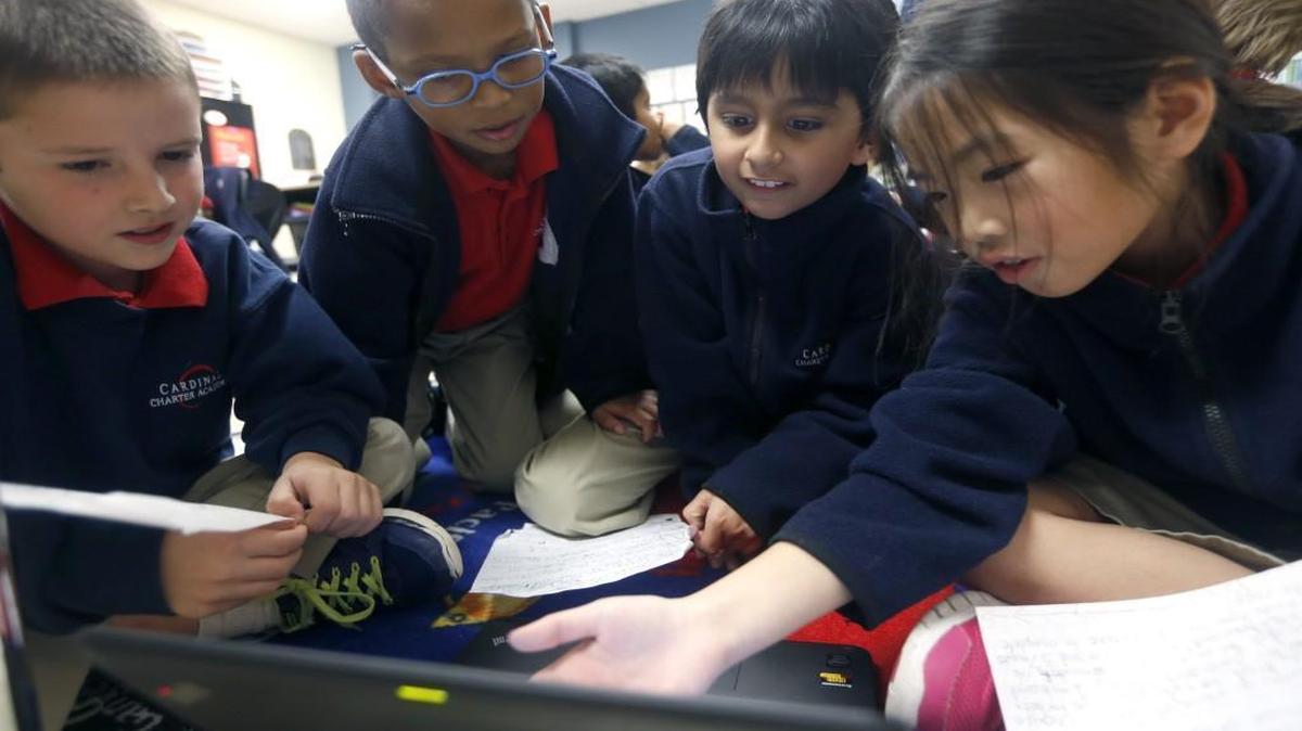 Third graders, from left, Jack McIlhargey, Alexis Trebeau, Krish Babu and Claire Nguyen work on making their own lesson plans at Cardinal Charter Academy in Cary, N.C., Wednesday, Dec. 2, 2015.