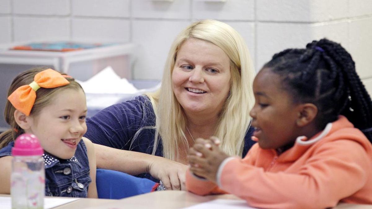 
Teacher Megan Presnell, center, listens in as students Ashley Stegman, left, and Ke-Mara Dunston collaborate during a lesson in a third grade class at Vance Elementary School in Garner on Tuesday,. 
