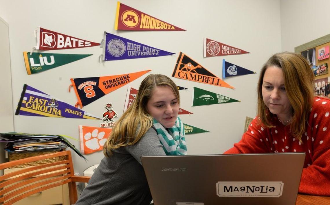 Cary student Hayley Hillison works with guidance counselor Lindsey Ringenbach, college counselor for juniors and seniors, as she looks over offers from various colleges during a break in classes at Research Triangle High in Durham in December 2016. Hillison has since graduated from the charter school and is a college student at William Peace University.