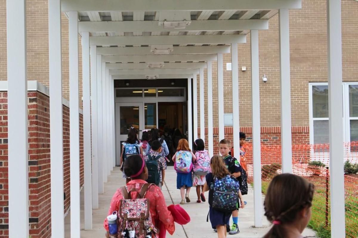 Students at Alston Ridge Elementary School in Cary walk into class in this 2014 file photo. The school will have an enrollment cap in the 2020-21 school year.
