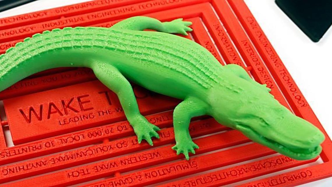 
A finely detailed polymer alligator in green and an intricately labeled mat listing the advantages of 3D printing technology were on display Saturday, August 15, 2015 for the second annual 3D Hub meet-up for 3D printing enthusiasts and business people Saturday, August 15, 2015 on the Wake Tech campus in south Raleigh.
