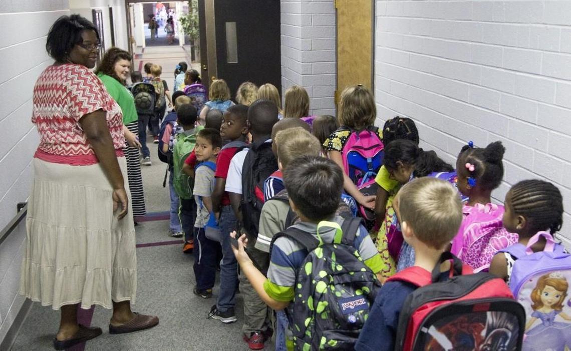 Teachers usher elementary students down the hall as they head for home at the end of the school day on at Raleigh Christian Academy in Raleigh on Aug. 21, 2014. In the 2016-17 school year, 90 students used taxpayer-funded vouchers to attend Raleigh Christian.