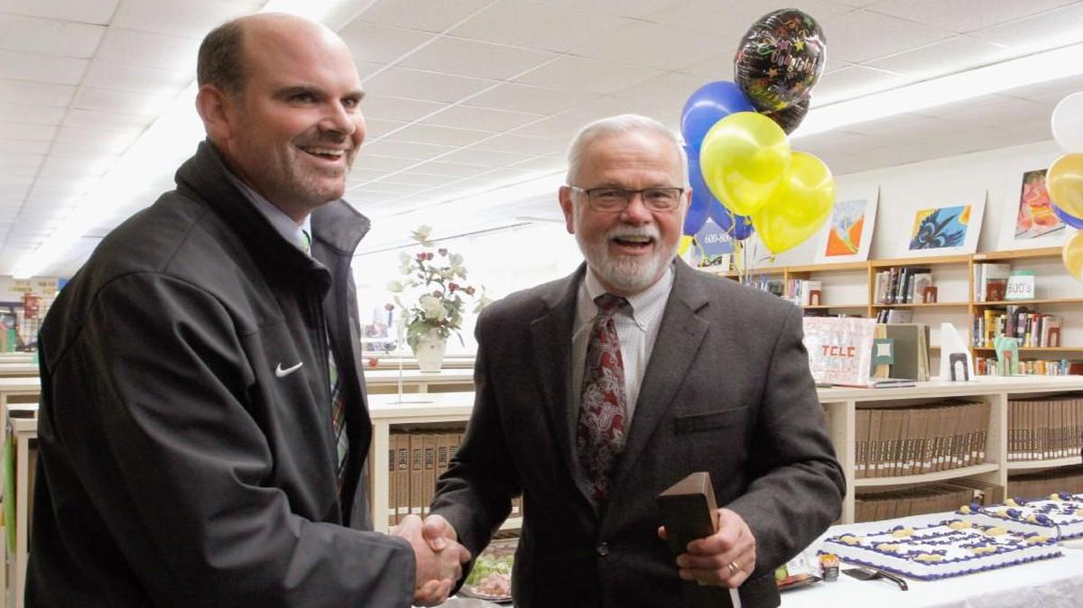 Northern High School Principal Matt Hunt, left, is congratulated by Superintendent Bert L’Homme, right, for being named the Durham Public Schools 2016 Principal of the Year. Hunt was named one of North Carolina’s eight finalists for 2016 Principal of the Year.