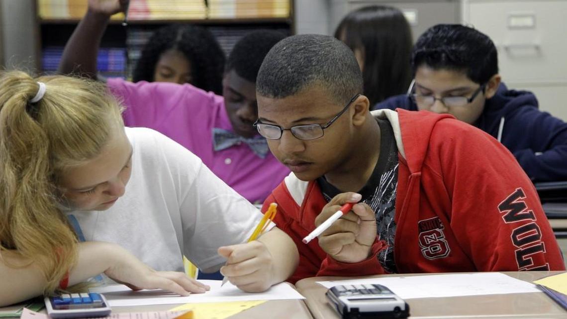 Cassie Bush, left, and Jason Phillips, right, collaborate on a problem during a math class at Athens Drive High School in Raleigh on Sept. 4, 2014.