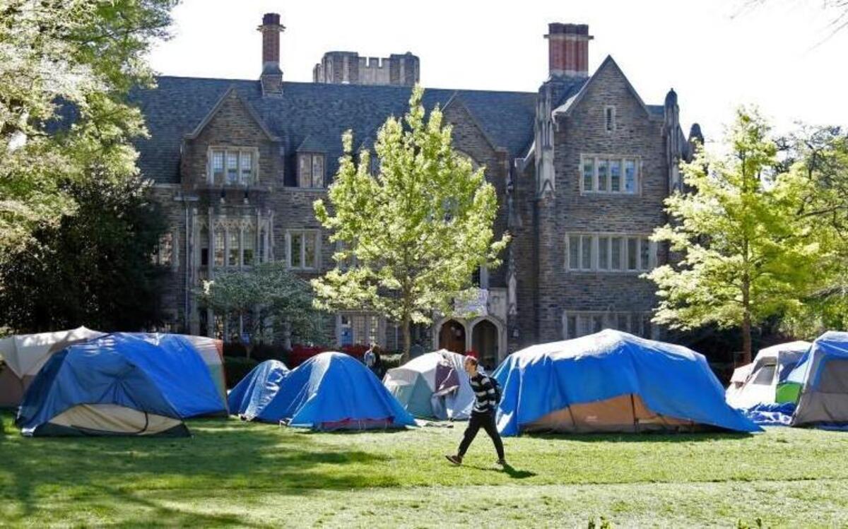 A student crosses the grassy Abele quad in front of the Allen Building on Duke's west campus Friday morning, April 8, 2016.