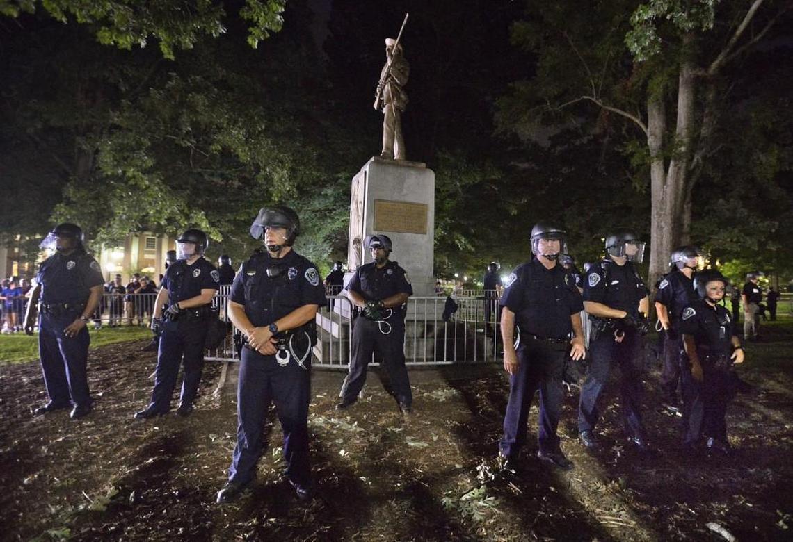 UNC-Chapel Hill police and Orange County Sheriff's deputies protect "Siolent Sam" on the campus of UNC- Chapel Hill in Chapel Hill, N.C. Tuesday, August 22, 2017. About 400 protesters surrounded the controversial statue for several hours as the students shouted "Tear it down".