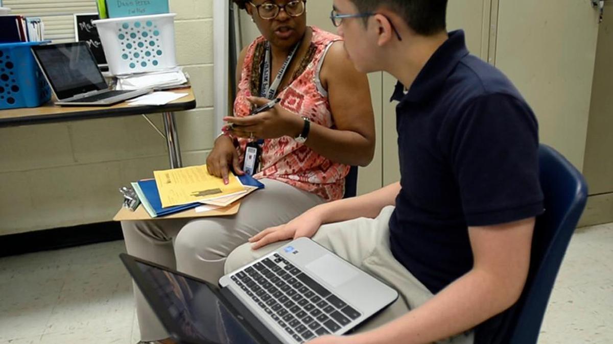 Victor Guevara talks with teacher Kiara Cox discussing his testing results in Math I class at Albemarle Road Middle School on Wednesday, April 5, 2017. Victor, whose parents are from El Salvador and don't speak English, has consistently made very high scores in math. In seventh grade the Duke Talent Identification Program honored him for SAT scores that would be above average for college-found seniors. But it takes a lot of support from faculty at Albemarle Road, where most students are poor and don't pass reading and math exams, and from church volunteers to keep him on track to reach his potential. He's in the high school-level math class after his counselor caught on that he'd initially been placed in regular math, despite his consistently high scores.