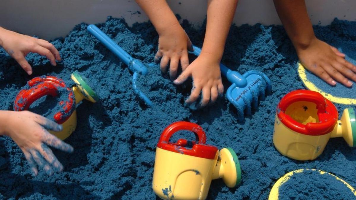 Holly Grove Elementary School kindergarteners play in tubs of blue sand in this 2007 file photo. Holly Grove is among 11 Wake County year-round schools that are being considered for calendar conversion.