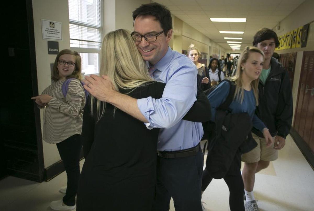 Broughton High School dance teacher Betsy Graves gets a hug from English teacher Richard Matkins after she was named the 2017-18 Wake County Teacher of the Year.