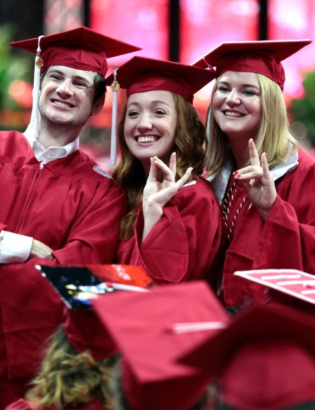 A clutch of NC State class of 2016 graduates stood for a friends and family photo from their seats on the floor of the PNC Arena Saturday, May 7, 2016. Over 5,600 graduated Saturday during NC State's Commencement ceremony at the PNC Arena in west Raleigh, NC.