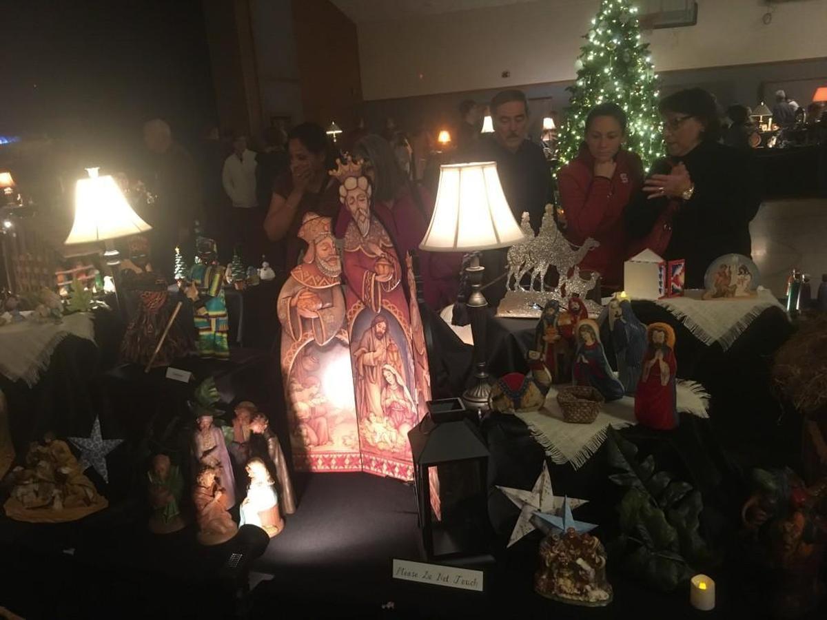 Visitors look at nativity scenes from around the world that are on display at the Raleigh Community Christmas Celebration on Thursday at the Church of Jesus Christ of Latter-Day Saints.