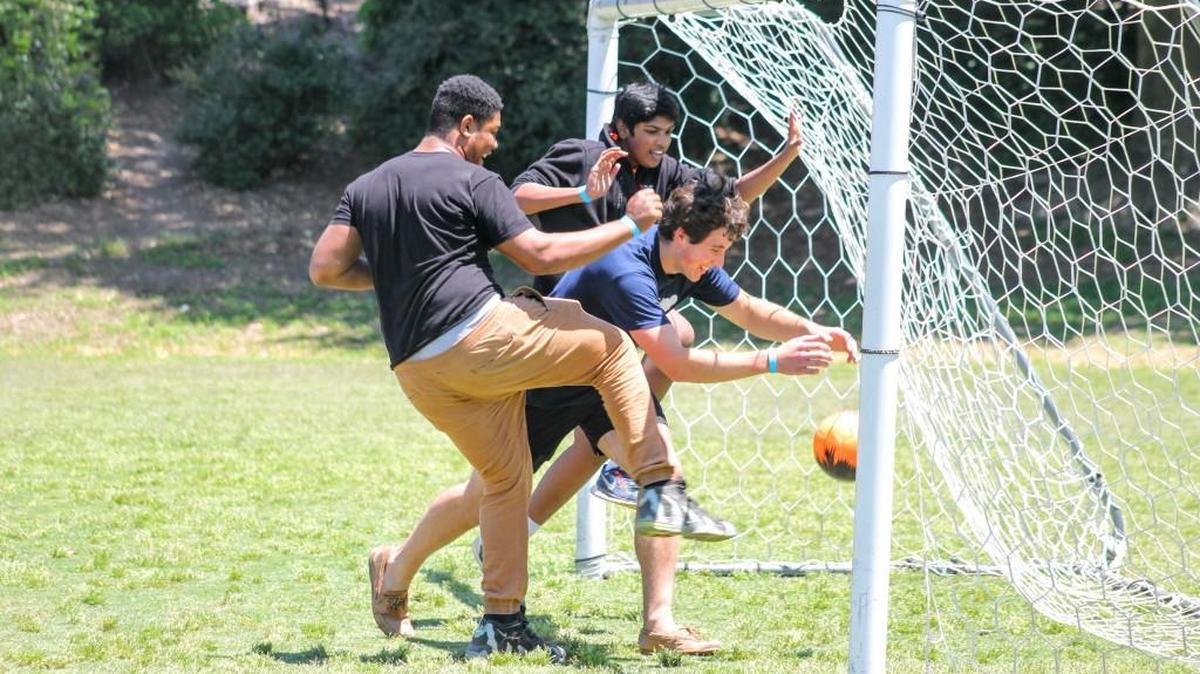 Members of the North Carolina School of Science and Mathematics Jóvenes Para Ayudar student group play soccer at the Green Hope Elementary park in Cary. The group organized a fiesta at the park to raise money for Hispanic student scholarships.