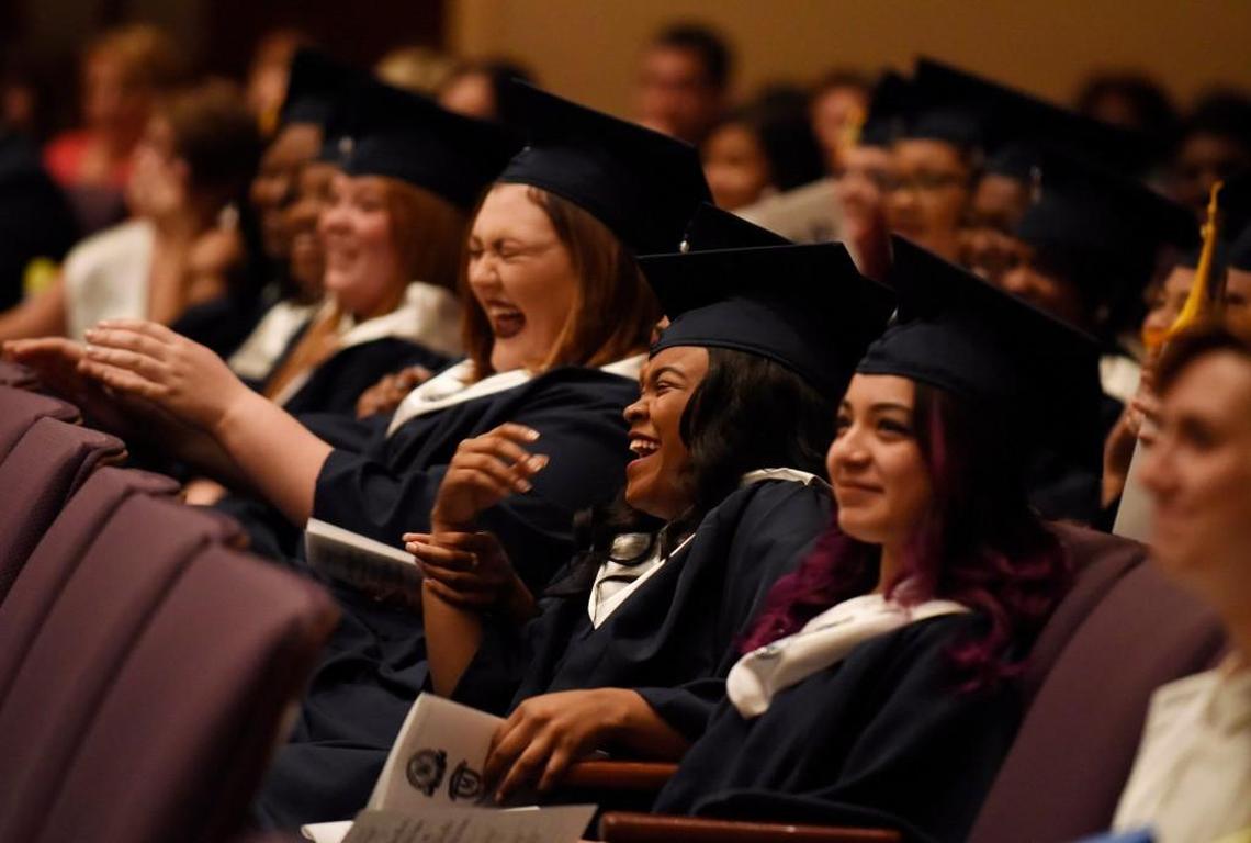 Brittany Bass, center, and Teresa Basaves, right, react to a classmate’s speech during the graduation ceremony for the Wake Young Men’s Leadership Academy and Wake Young Women’s Leadership Academy in Raleigh, N.C. on Tuesday, May 24, 2016.