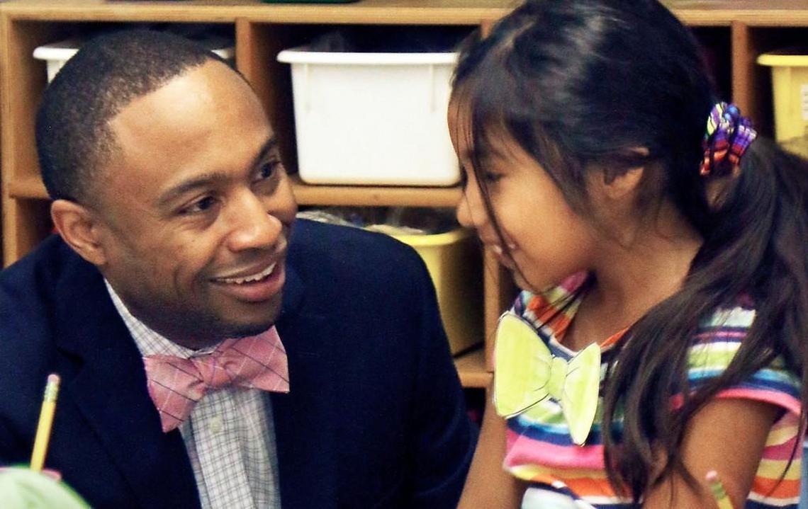Brentwood Elementary principal Eric Fitts, 41, checks out the colorful paper bow tie of second grader Andrea Alvarado Thursday morning, October 8, 2015 during Fitts morning rounds at the start of classes. Fitts was named Wednesday night as the Wake County school system’s 2015 Principal of the Year. Fitts has been principal at Brentwood for two and a half years at the 385 student K-5 magnet engineering school. Students and staff all wore makeshift or real bow ties at school Thursday in honor of their principal.