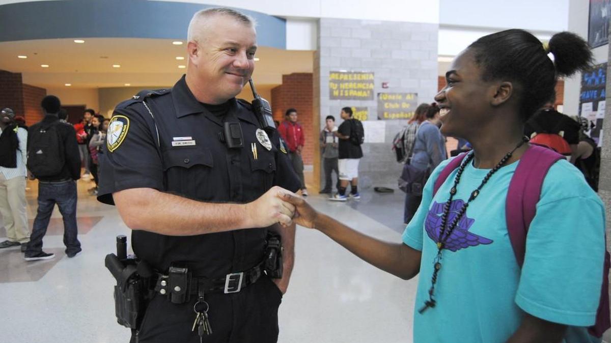 Knightdale High School resource officer Pete Smith talks with a student on campus. The Wake County school system may create a new program to try to encourage more students to consider careers in law enforcement.