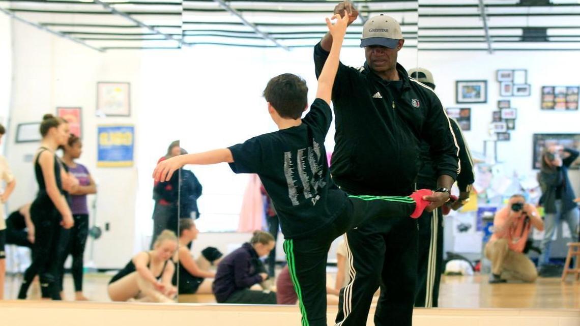 Mel Tomlinson works with seventh-grader Yoni Ram while he works with members of the Ligon GT Magnet Middle School dance company on Jan. 21, 2016. Wake County’s magnet school application period runs from Jan. 12-31, 2017.