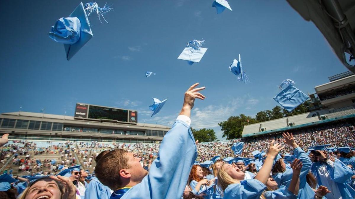 UNC class of 2016 graduates toss their caps into the air at the end of a graduation ceremony at Kenan Memorial Stadium in Chapel Hill, N.C. on Sunday, May 8, 2016.